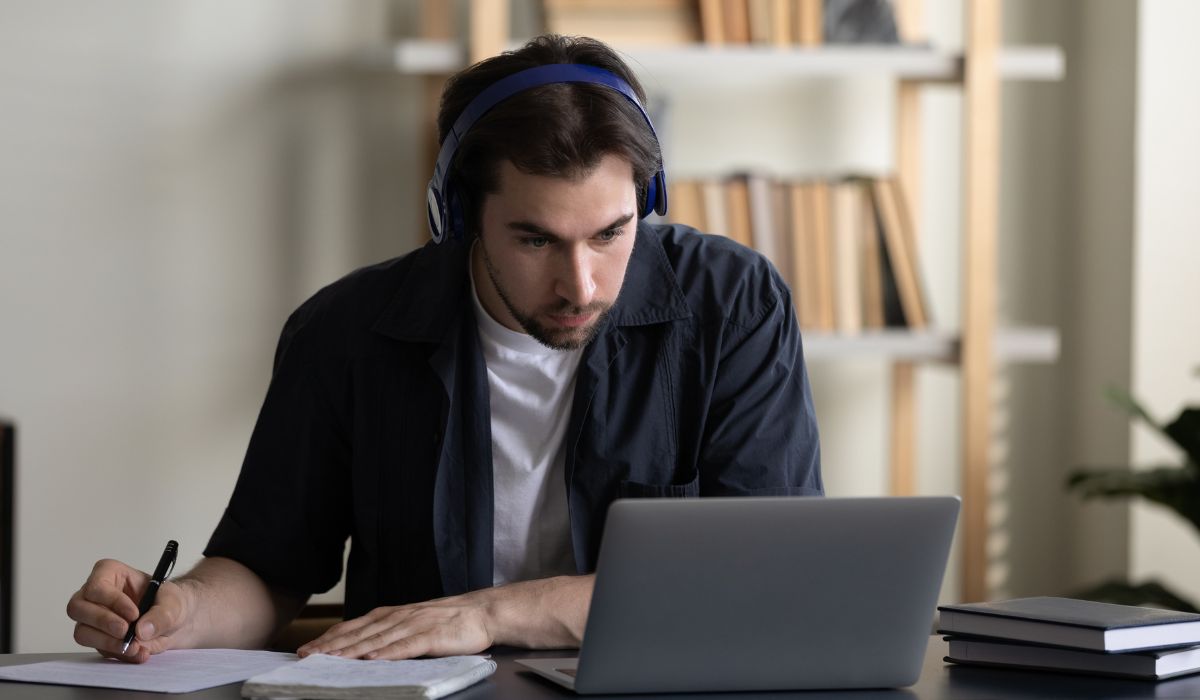 An adult student at his laptop taking an online course from Iowa Valley Community College District