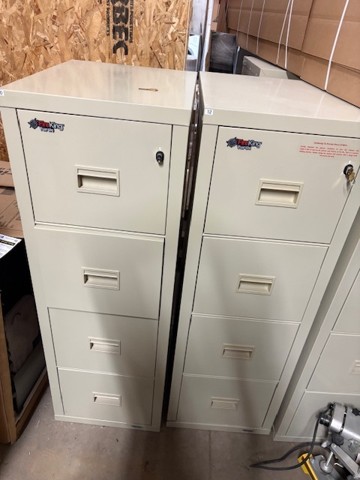 Two visible FireKing filing cabinets in storage. Each cabinet is four drawers tall.
