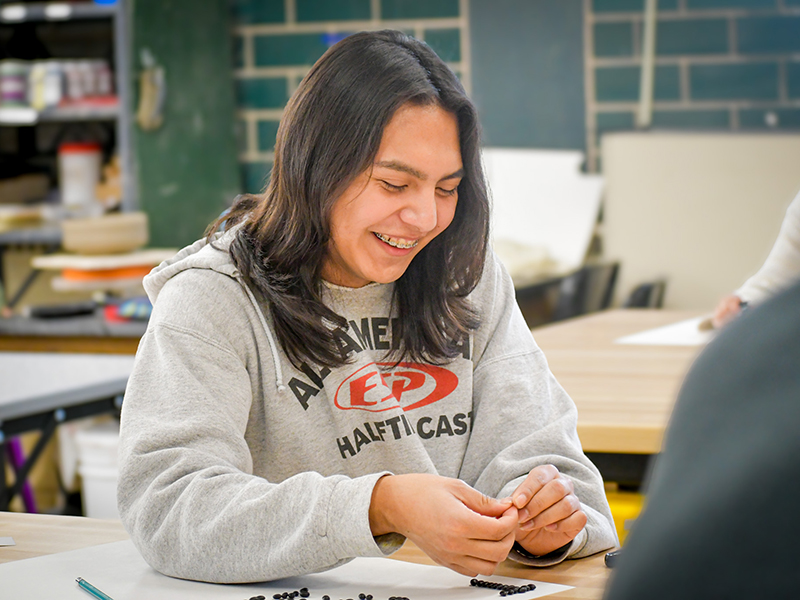 Student participating in art club activity.