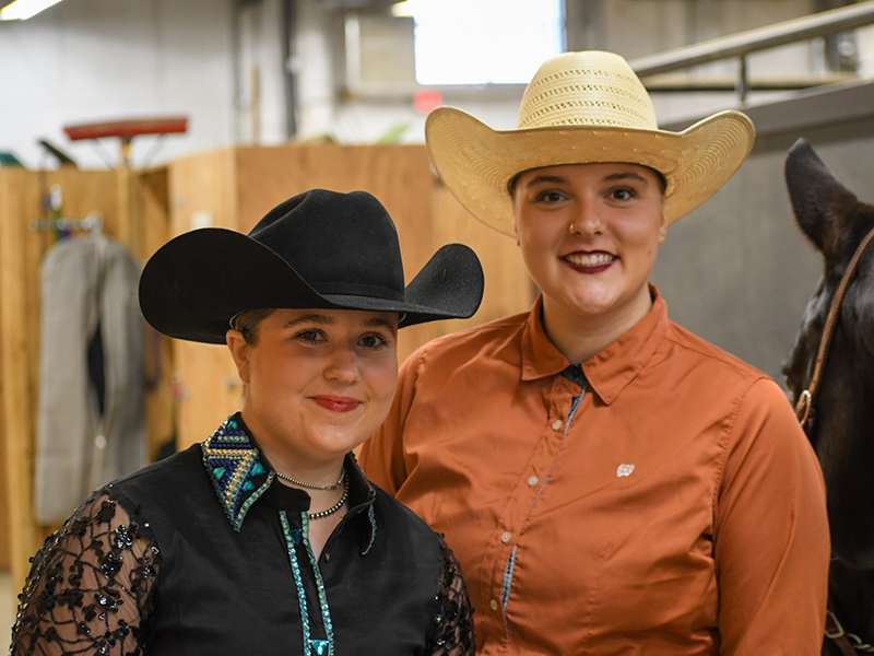 Two students taking a picture during an IHSA event.