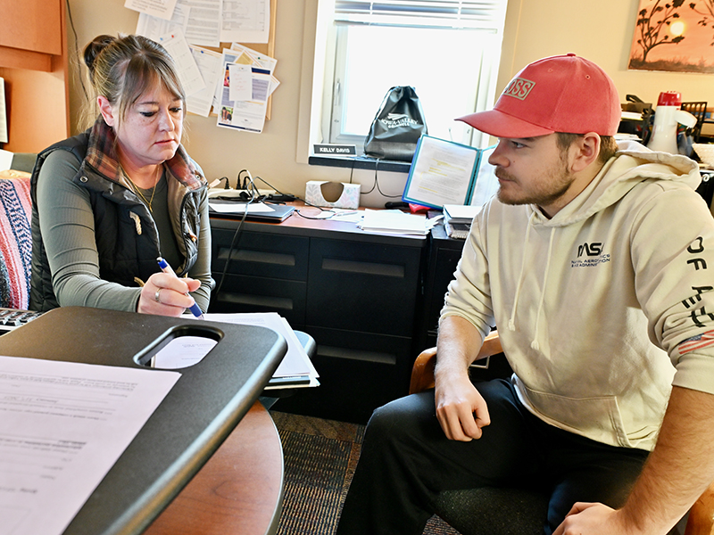 kelly working with student in office