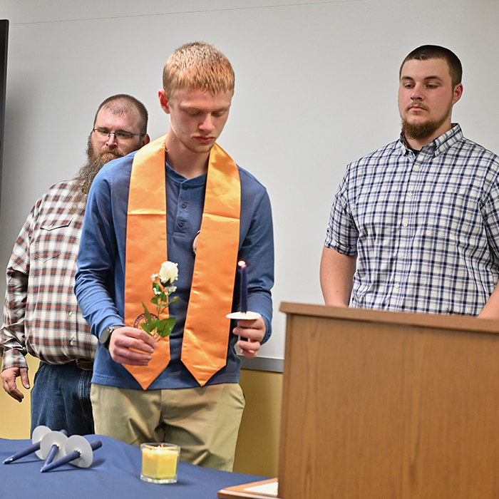 PTK Induction student-lighting-candle-at-PTK-ceremony