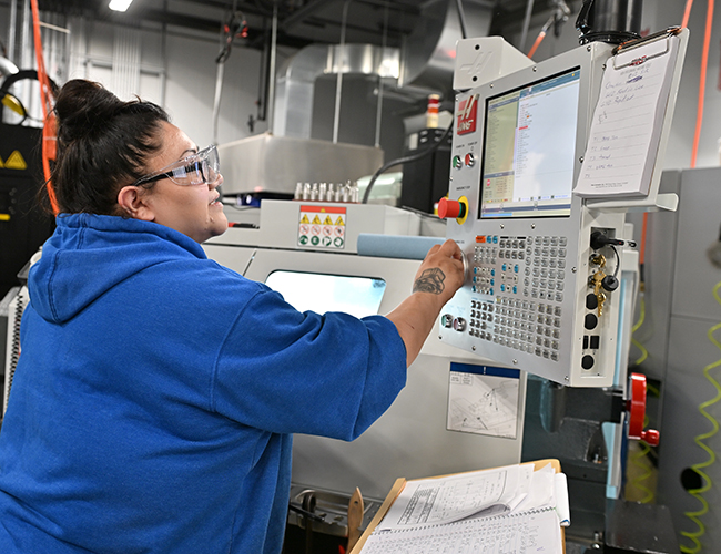 Advanced Manufacturing female student working on machine