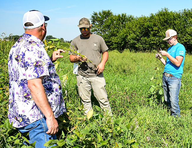 Agribusiness students and instructor in field