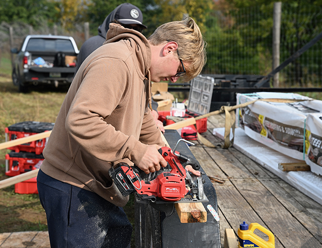 Construction Technology student using saw