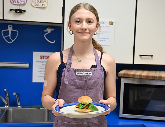 Culinary female student holding food
