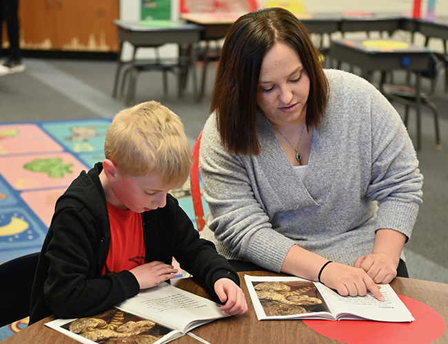 Elementary Education college student working with elementary student