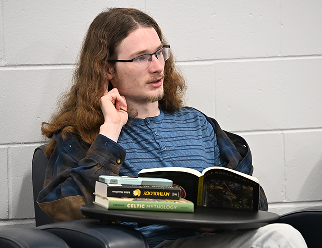 student in classroom with books