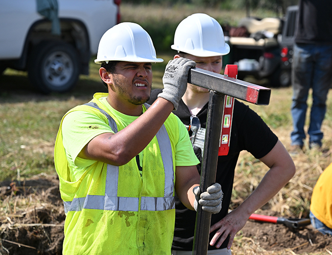 students working outdoors on digging projects