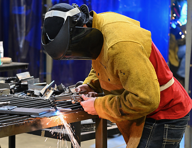 Welding student working on welding project